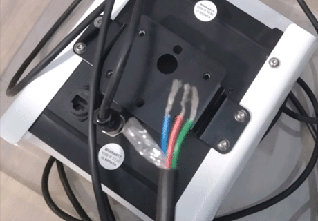 A black and white box with wires  Description automatically generated